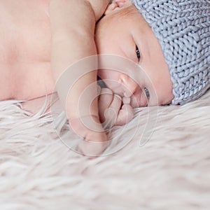 Little newborn baby on white background, face closeup