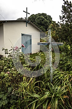 Little old chapel with wooden cross in coutryside