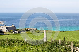 a little old farm near a beautiful and pristine bay on Westray, Orkney, Scotland photo
