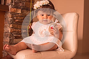 Little one year girl baby with balones and dolly photo