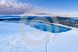 Little Payette Lake in winter aerial view with winding creek