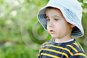 Little pensive boy in jeans hat