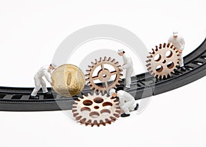 Little people dolls with gears and coin on rails