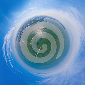 Little planet 360 degree sphere. Panorama of aerial view of aquaculture nets for fish farm in a lake in Sri Racha, Chonburi,