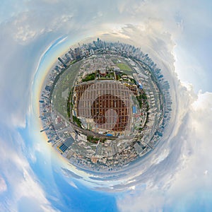 Little planet 360 degree sphere. Panorama of aerial view of busy industrial under construction site workers working with cranes