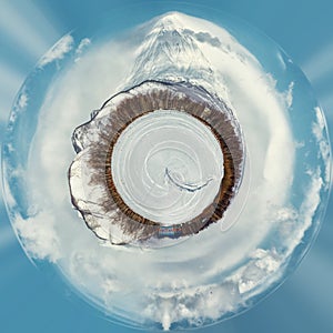 Little planet 360 degree sphere. Panorama of Koryaksky volcano and surrounding snow-covered countryside. Kamchatka.