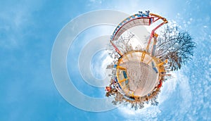 Little planet with amusement park, trees and cold blye sky. Nice background. photo
