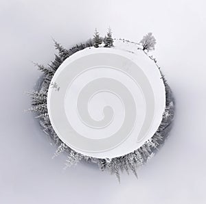 Little planet panorama of snowy hills montains landscape with forest.