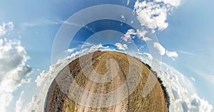 Little planet rotates in beautiful blue sky with rain clouds. tiny planet transformation with curvature of space. loop
