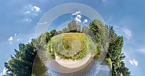 Little planet Transformation with curvature of space. Abstract torsion and spinning of full flyby panorama in forest near lake