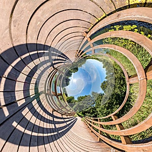 Little planet transformation of spherical panorama 360 degrees. Spherical abstract aerial view on wooden bridge. Curvature of