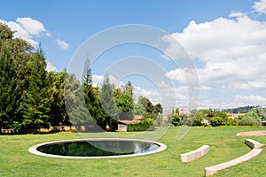 Little pond in the gardens of Quinta das Lagrimas and stone seats in Coimbra, Portugal photo