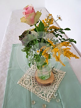 little posy in a glass, floral table decoration with rose flower