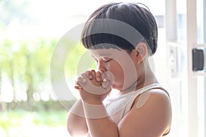 A little prayer, A boy is praying seriously and hopefully to Jesus