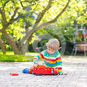 Little preschool boy playing with car toy