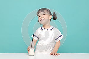 Little pretty Asian girl laughing portrait with milk and bread, healthy and happy lifestyle