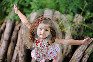 Little pretty girl in the green garden