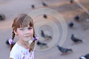 Little pretty girl with pigtails smiles