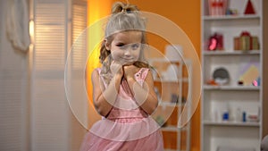 Little princess in adorable pink dress, childhood dream, happy preschool girl