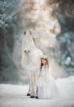 The little princess with an unicorn in the forest.