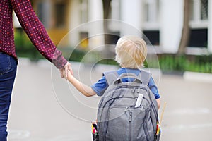 Little pupil with his young mother. First day of primary school.