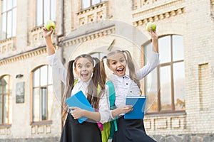 Little pupil with notebook and apple. lunch time at school break. happy kids in uniform. learning subject together