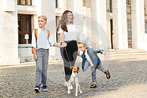 Little puppy jack russel terrier and owners on a walk. Family, pet and lifestyle. Happy family