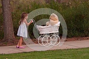 Little pushing toy baby buggy which is white wicker