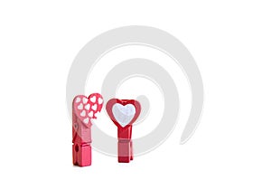 Little red clothespins hearts. On white background. Love