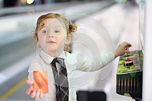 Little red hair girl in white shirt and tie plays