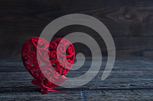 Little red heart on a wooden background. Love