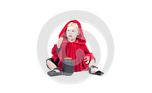 Little Red Riding Hood. Beautiful little girl in a red raincoat. Halloween