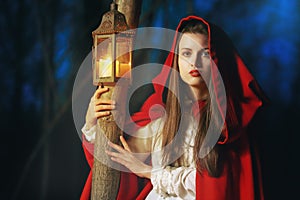 Little Red riding hood lighted by a lantern