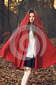 Little Red riding hood posing in the forest