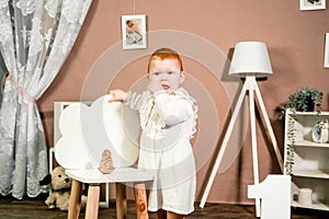 Little redhead baby girl celebrates first birthday anniversary. 1 year family party Professional photoshoot in photo