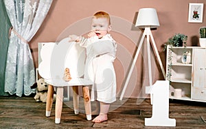 Little redhead baby girl celebrates first birthday anniversary. 1 year family party Professional photoshoot in photo