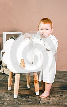 Little redhead baby girl celebrates first birthday anniversary. 1 year family party Professional photoshoot in photo