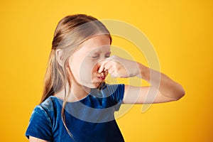 Little Redhead Girl Covering Nose For Bad Smell