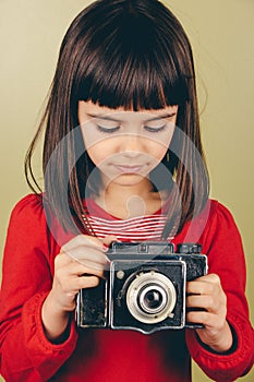 Little retro photographer with an old camera