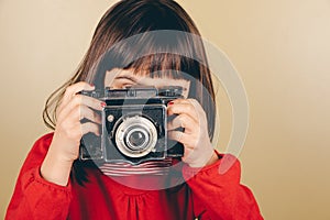 Little retro photographer with an old camera