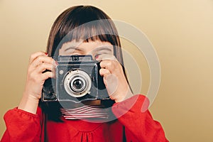 Little retro photographer with an old camera