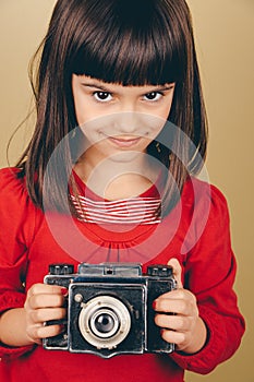 Little retro photographer with an old camera