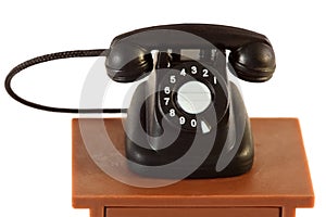 Little retro telephone on table isolated