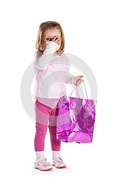 Little sad girl with shopping bag