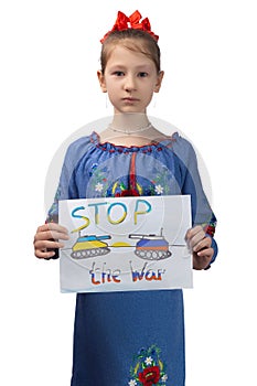 A little sad Ukrainian girl holds a drawing in her hands with the inscription