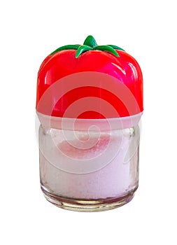 Little saltshaker with a tomato top full with salt on a white background