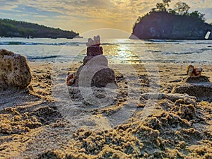Little sand castles made by children in the cystal beach of Nusa Penida island of bali, Indonesia