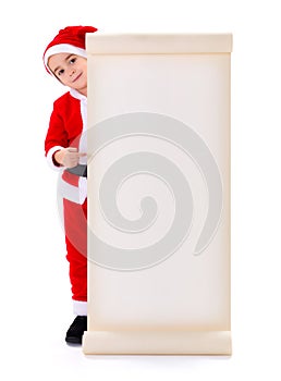 Little Santa Claus boy pointing at big wish list