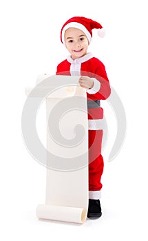 Little Santa Claus boy showing wishlist