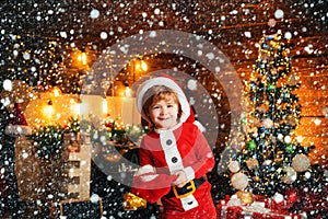 Little Santa Claus helper elf with a magic gift for Christmas. Christmas shopping concept. Gifts service. Little genius